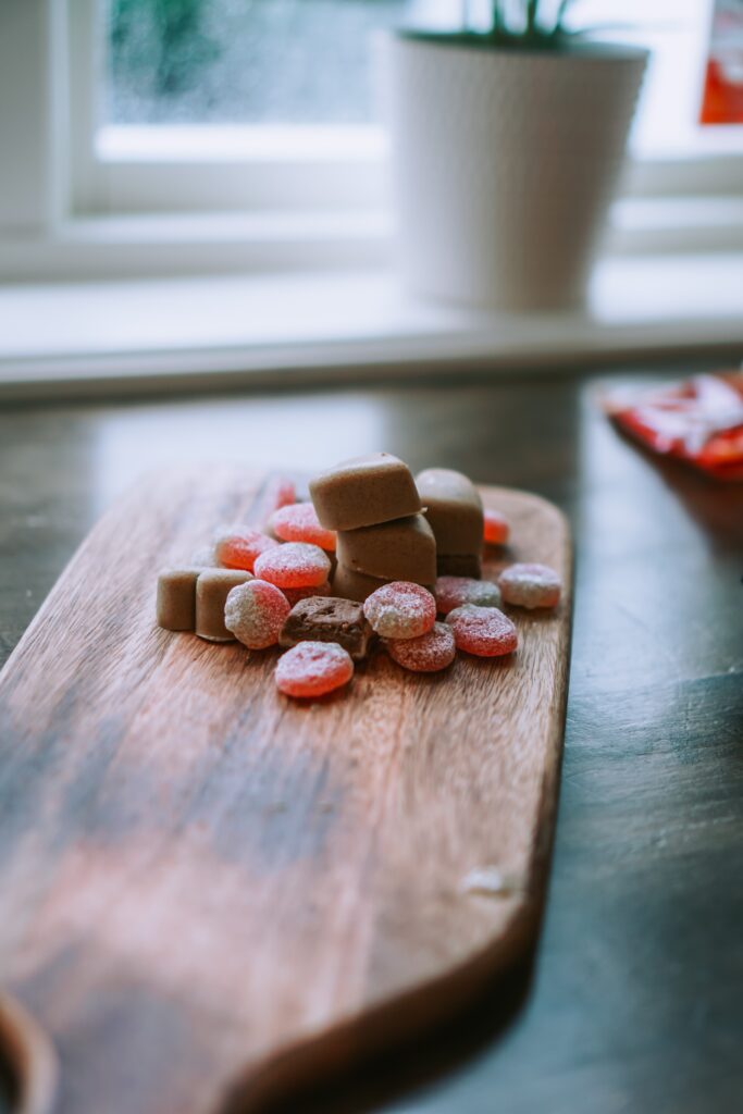 Bonbons and sweets on a wooden board