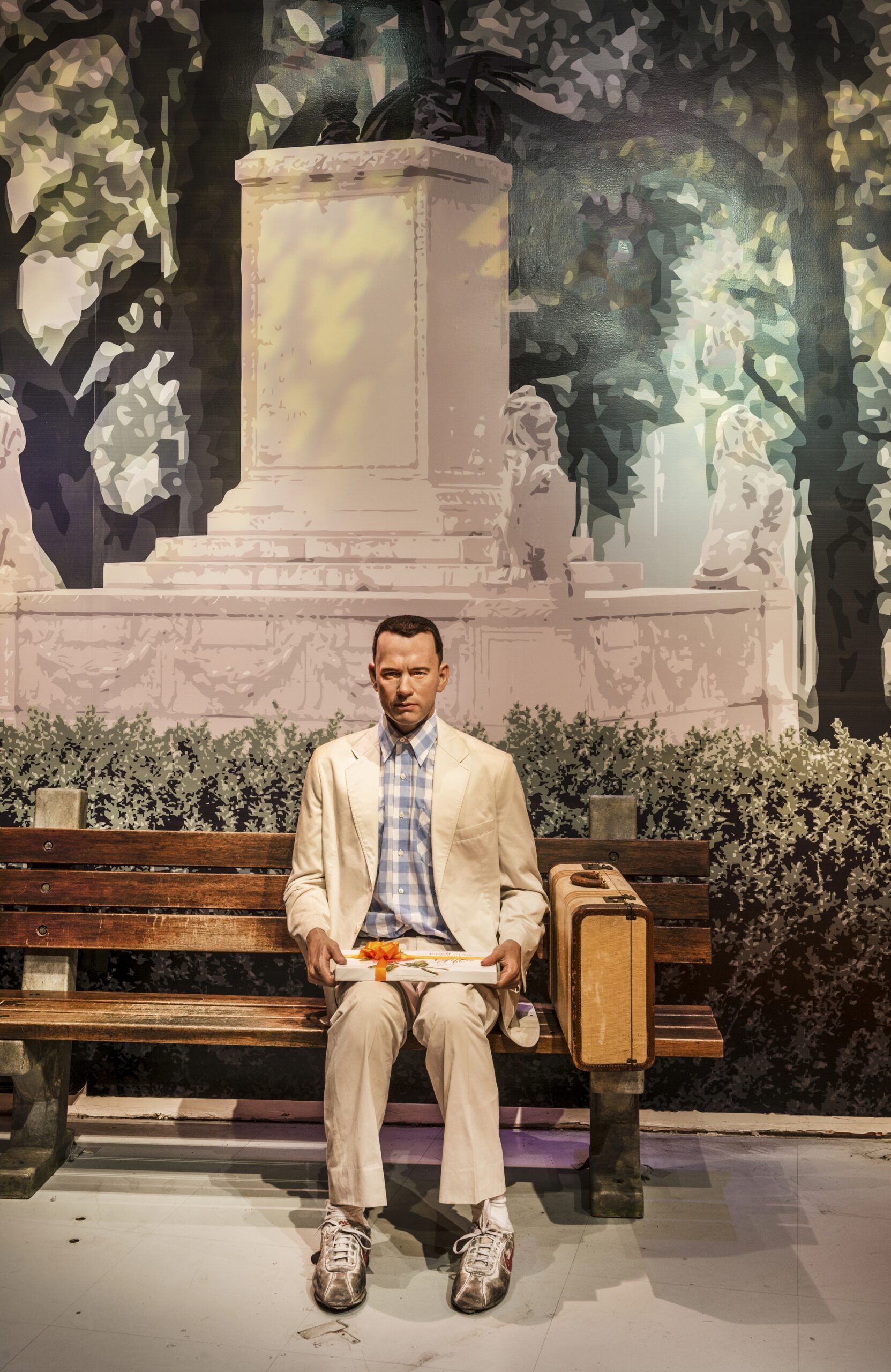 Wax model of Forrest Gump sitting on a bench